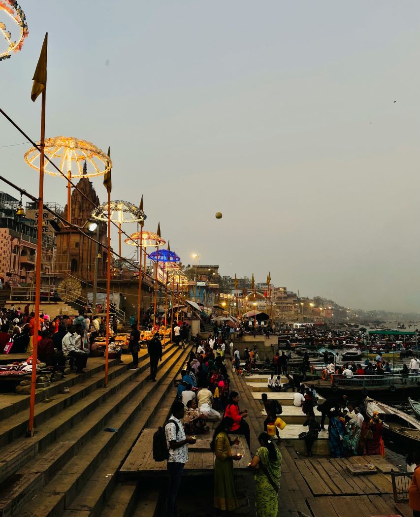 Varanasi a group of people standing on top of a-pier