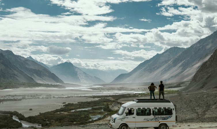 Ladakh two person on top of white van
