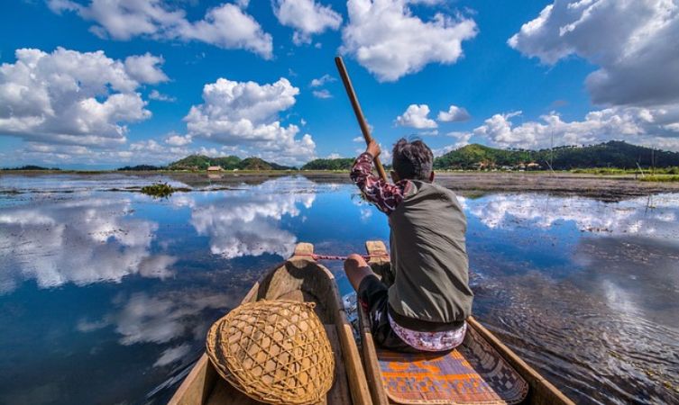Loktak Lake a man boating in loktak lake