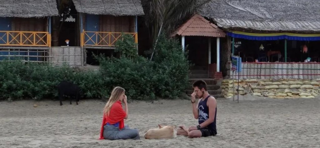 people doing Yoga on a beach in gokarna
