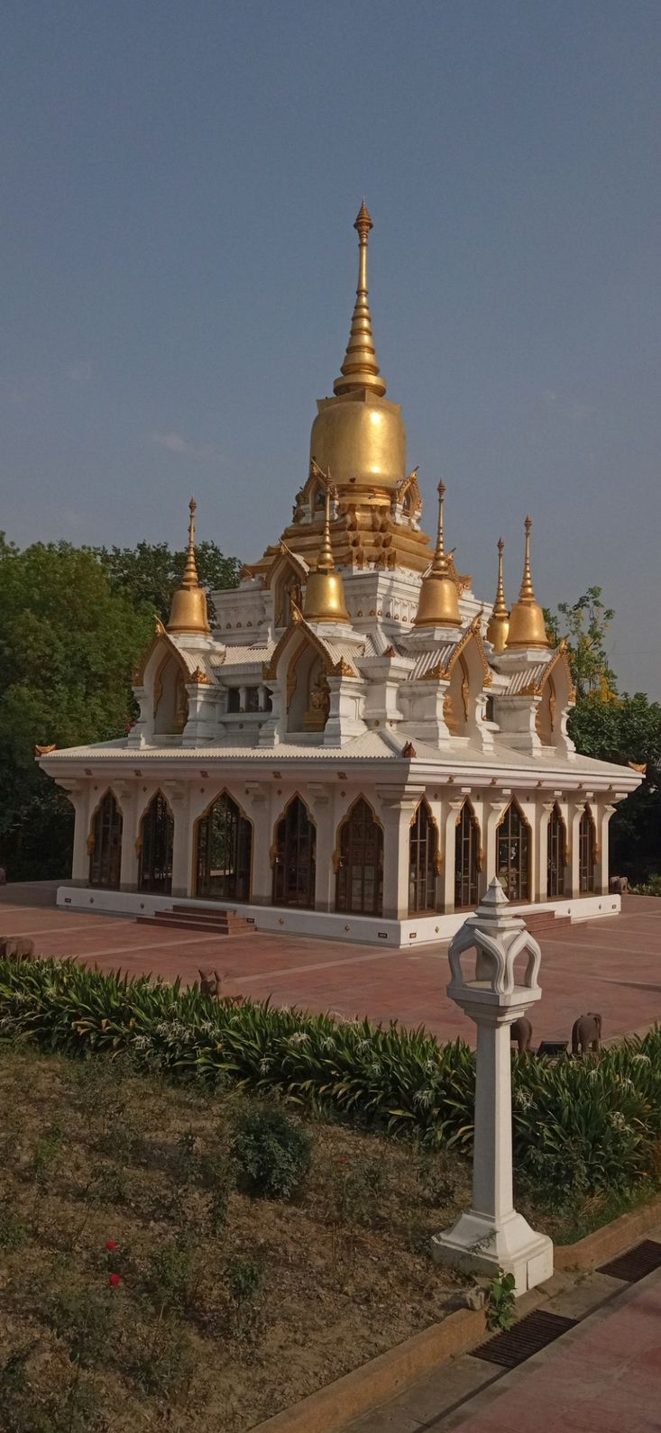 a large white and gold building sitting in a park