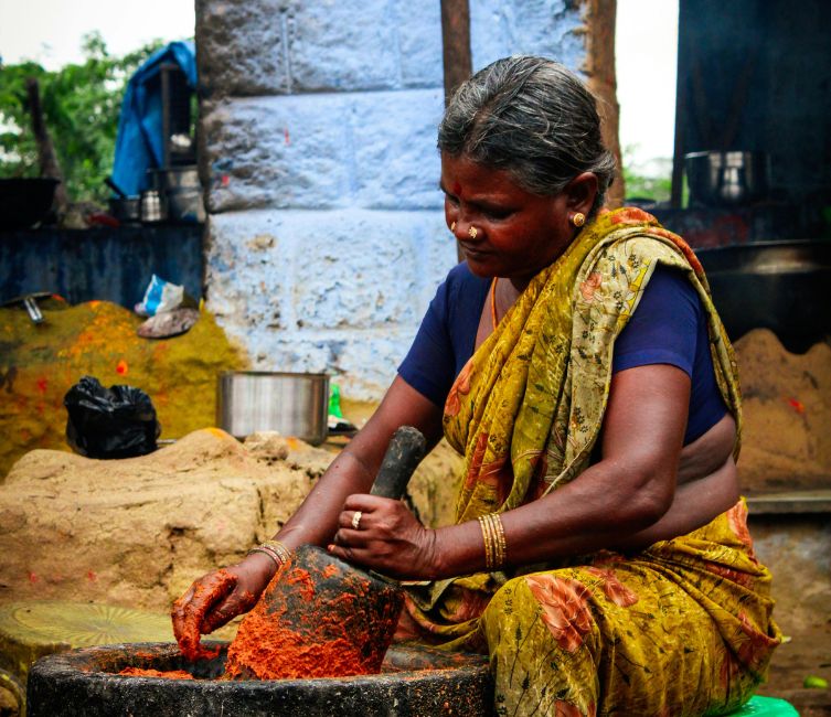 a woman grinding spices 