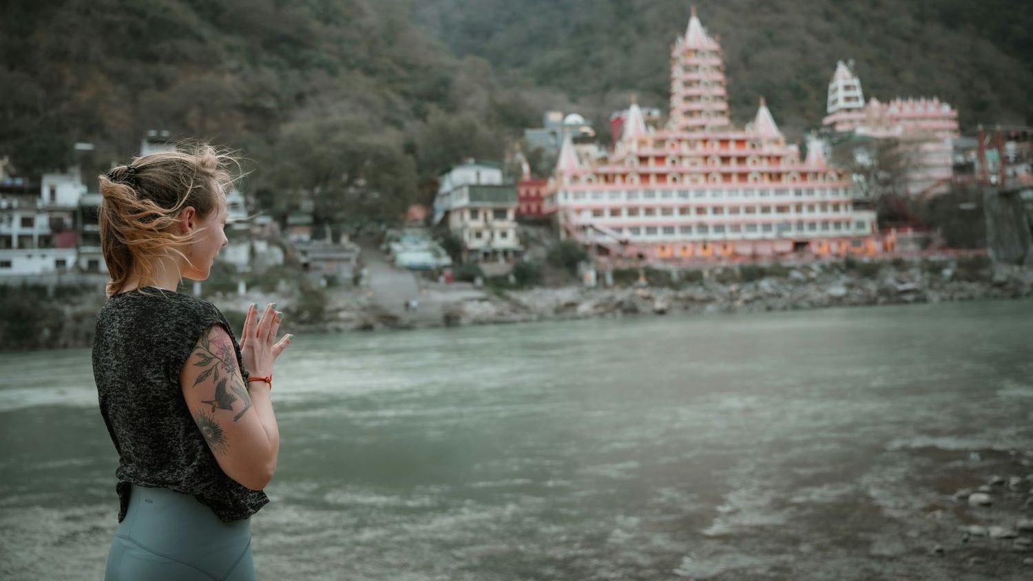 surreal view of rishikesh in india a woman standing on riverside in rishikesh in India